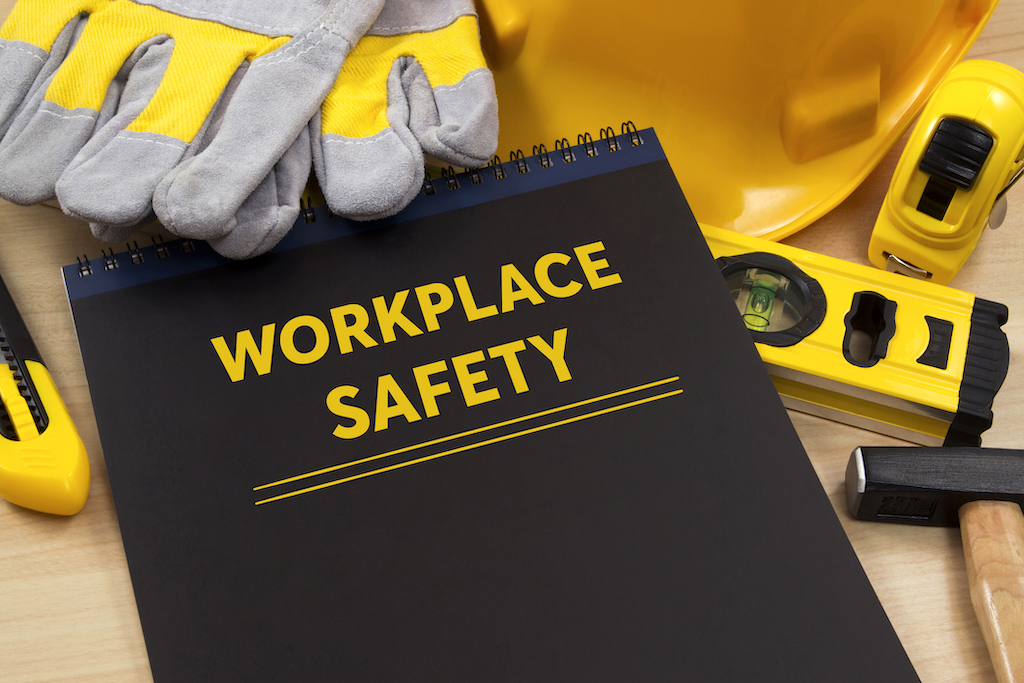 Workplace safety manual with tools representing generator emergency services safety practices.