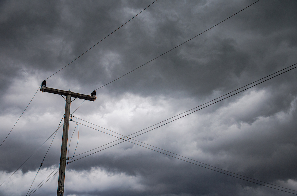 Power line with stormy sky in background. | Generator services 